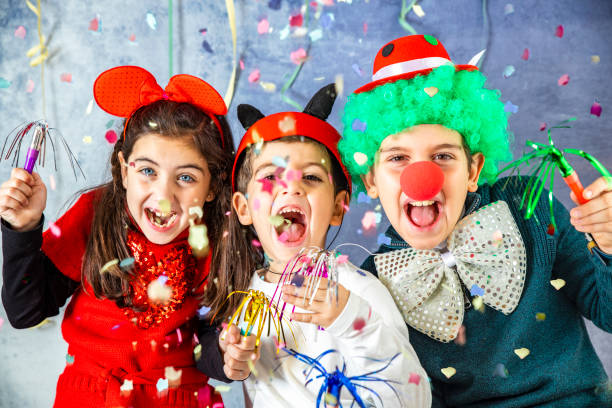Kids celebrating with confetti and party costumes
