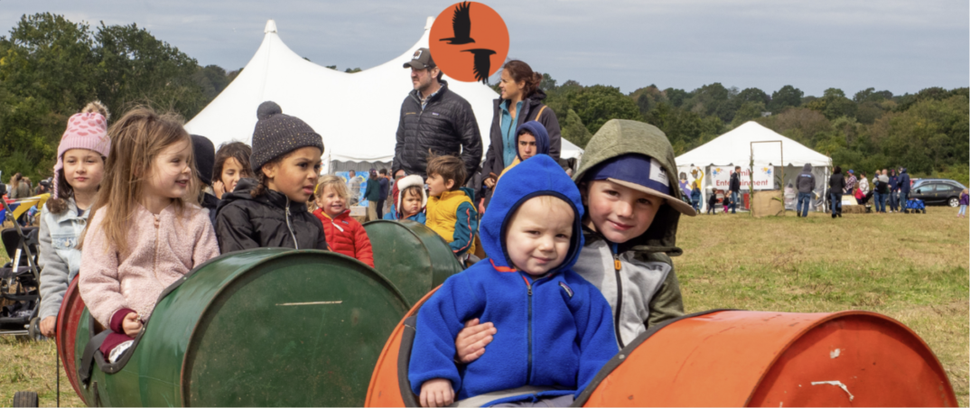 Kids on a barrel train ride at the Norman Bird Sanctuary Harvest Fair